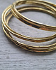 bransoletki złote Komplet sześciu bransolet z mosiądzu