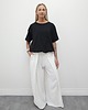 spodnie materiałowe damskie Tkaninowe spodnie boucle z zakładkami - Cream