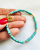 bransoletki z kamieni naturalnych Turkusowa bransoletka  z kamieni, złota rozetka