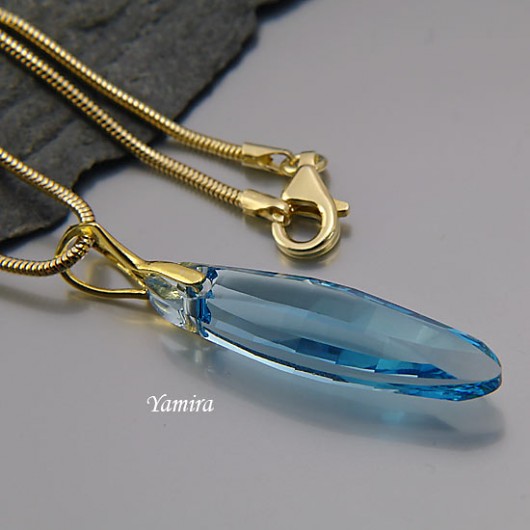 kryształ Swarovski Ellipse Aquamarine złote 32mm wisior yamira