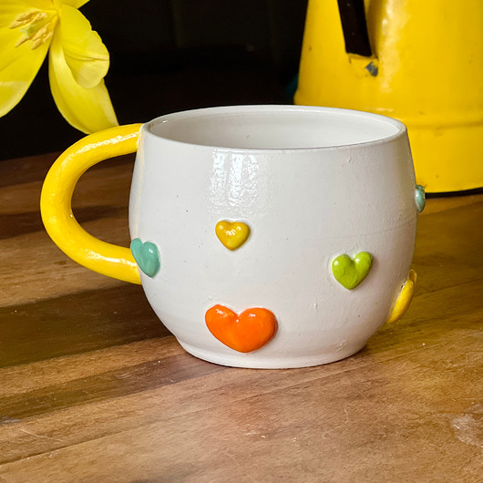 kubki Kubek ceramiczny z kolorowymi serduszkami i żółtym uchwytem